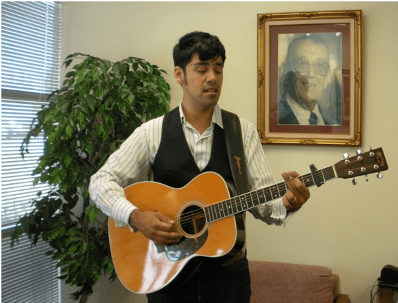 Antonio of K-EARTH 101 performs for us in the lobby, beside our founder Case Hoffman. 